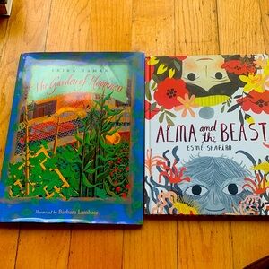 Two hardcover children’s books. The garden of happiness and Alma and the beast